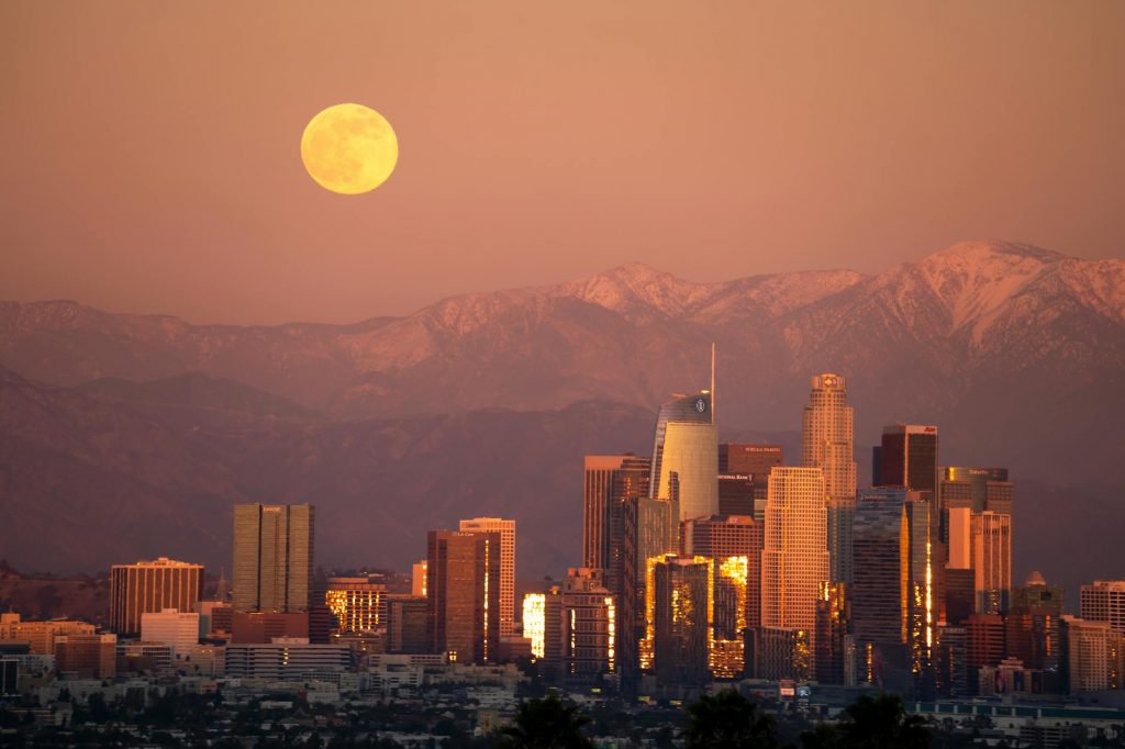 full moon over city skyline during night time